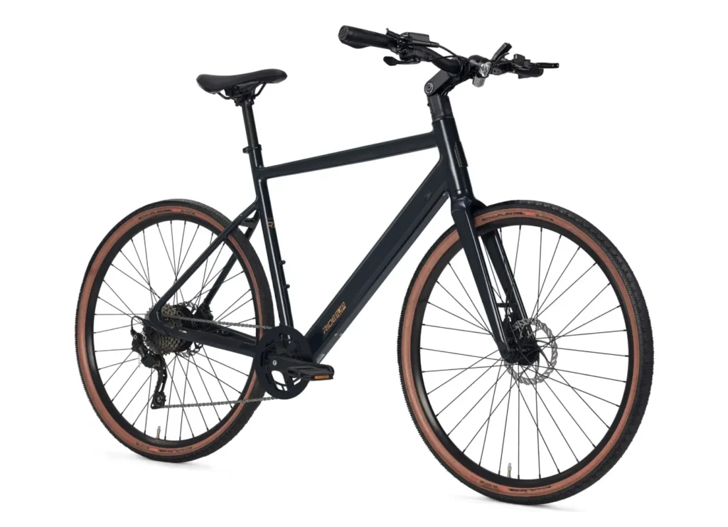 Product photo of the Ride1Up Roadster V3 ebike from the right 1/4 profile view. The bike has 700c tanwall tires, fenders, and a mostly traditional double diamond frame. The downtube is a little thick because it holds the battery