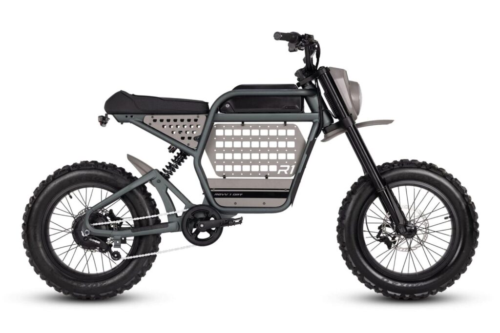Product photo of the Ride1Up Revv1 ebike from the right profile. The ebike feature small chunky wheels with fat tread, and a spartan, quasi militaristic frame with molle and other design/functional aspects.