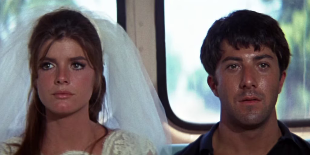 Still from the ending of the movie "The Graduate" where the protagonist declares his love for a young woman about to be married and the run away from the church together and onto a bus. The photo is of the young couple - she still in her wedding gown - sit in the back of the bus with worried, uncertain looks on their faces.